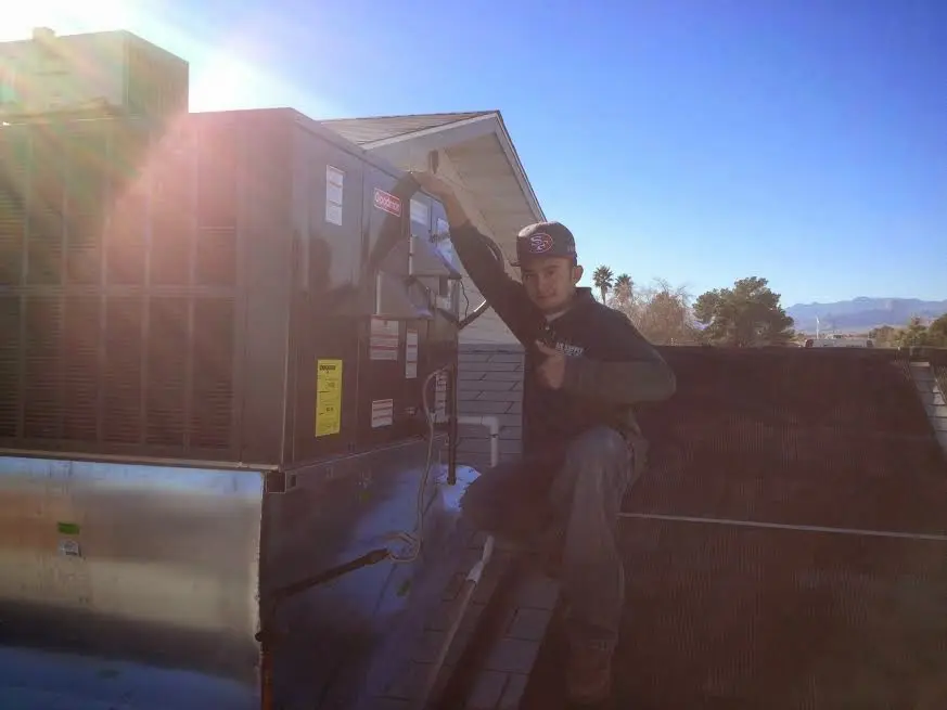 HVAC technician performing AC Tune-Up on a rooftop unit in La Cresta